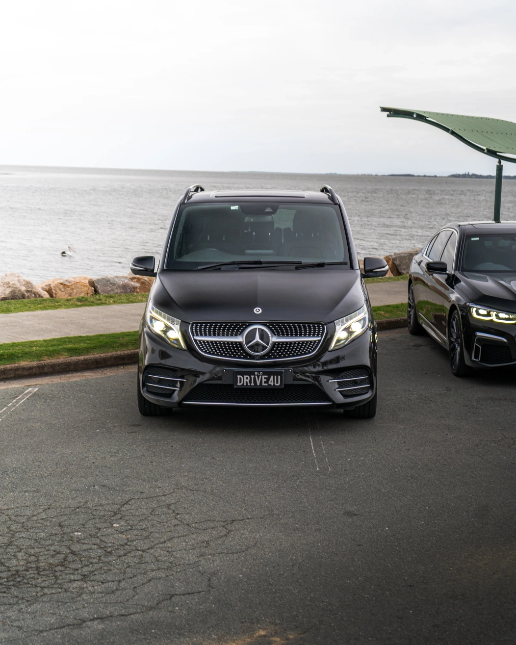 Professional chauffeur with luxury car